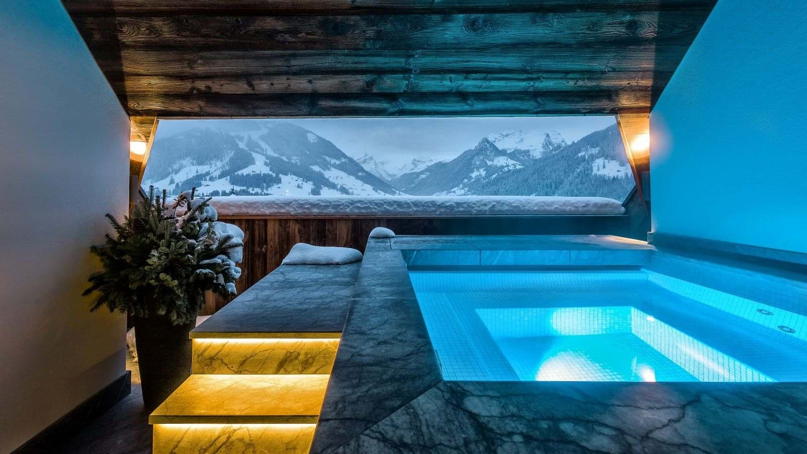Covered outdoor hot tub with heated steps and mountain views