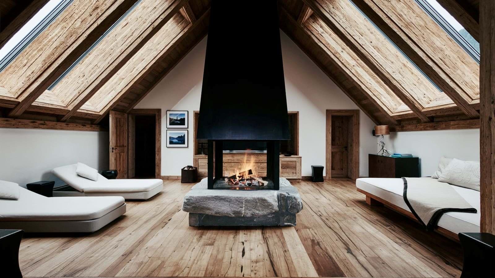 Lounge with central stone fireplace and skylight windows