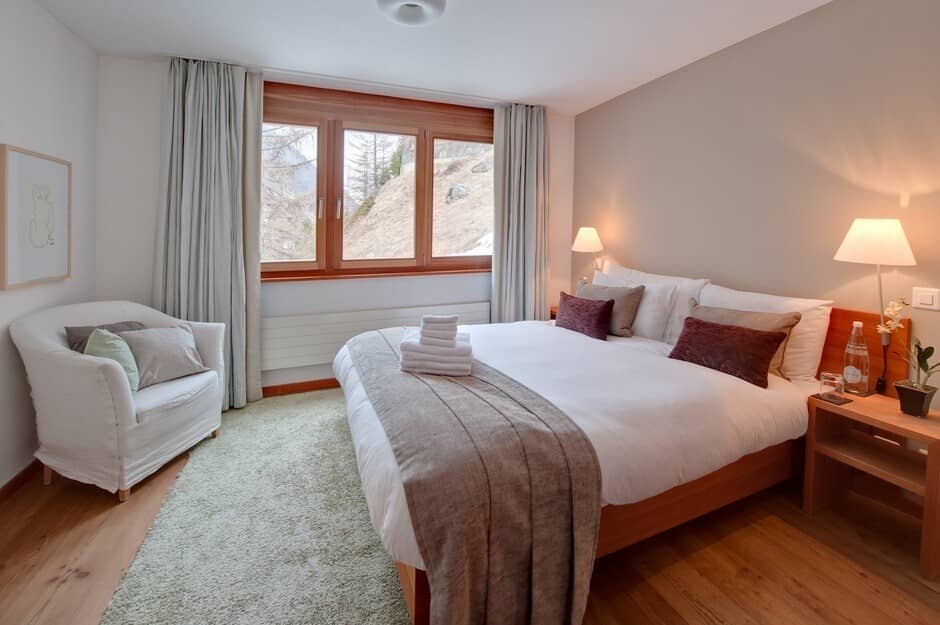Guest bedroom with king bed and mountain slope views
