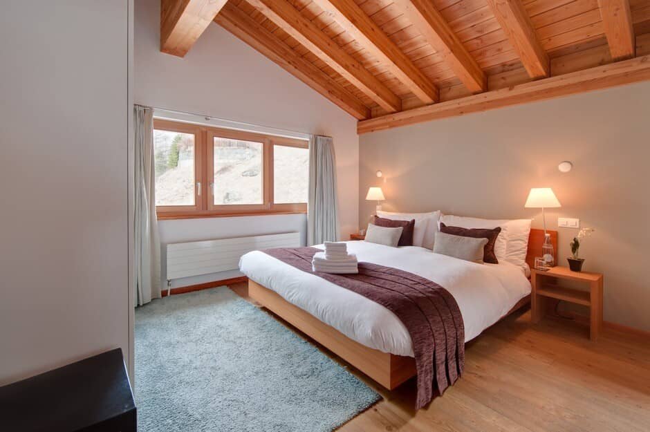 Bedroom with king bed and exposed timber vaulted ceiling