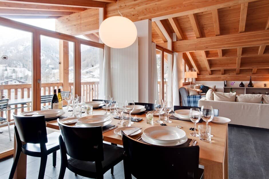 Dining area with seating for 8 and mountain views via balcony doors