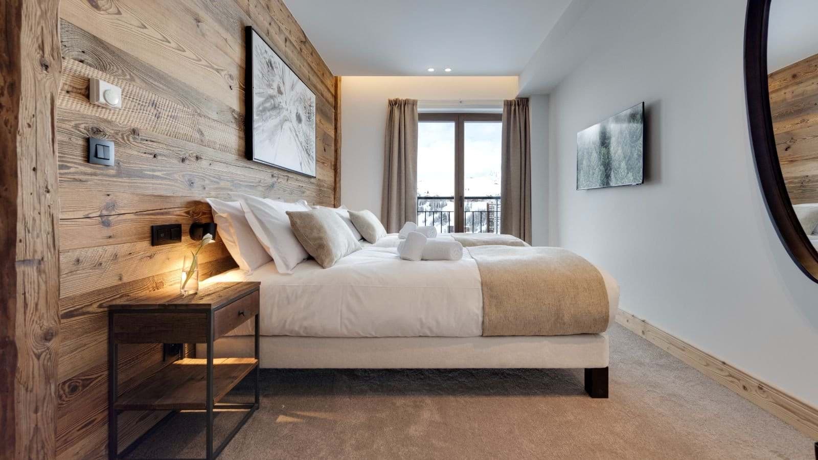 Guest bedroom with twin beds and private balcony access