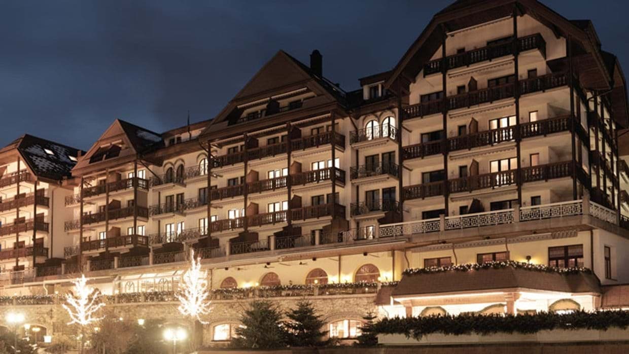 Chalet-style exterior with private balconies and ground-floor terrace