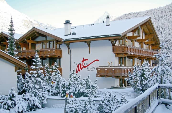 Chalet exterior with private balconies and snow-covered mountain views
