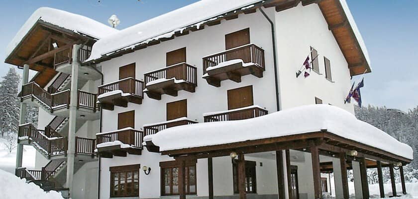 Chalet exterior with private balconies and covered ground-floor terrace