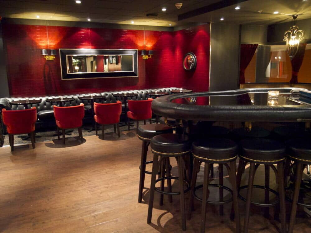 Lounge area featuring barstools and tufted leather banquette seating