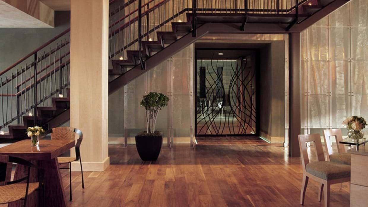 Foyer with industrial staircase and temperature-controlled wine cellar