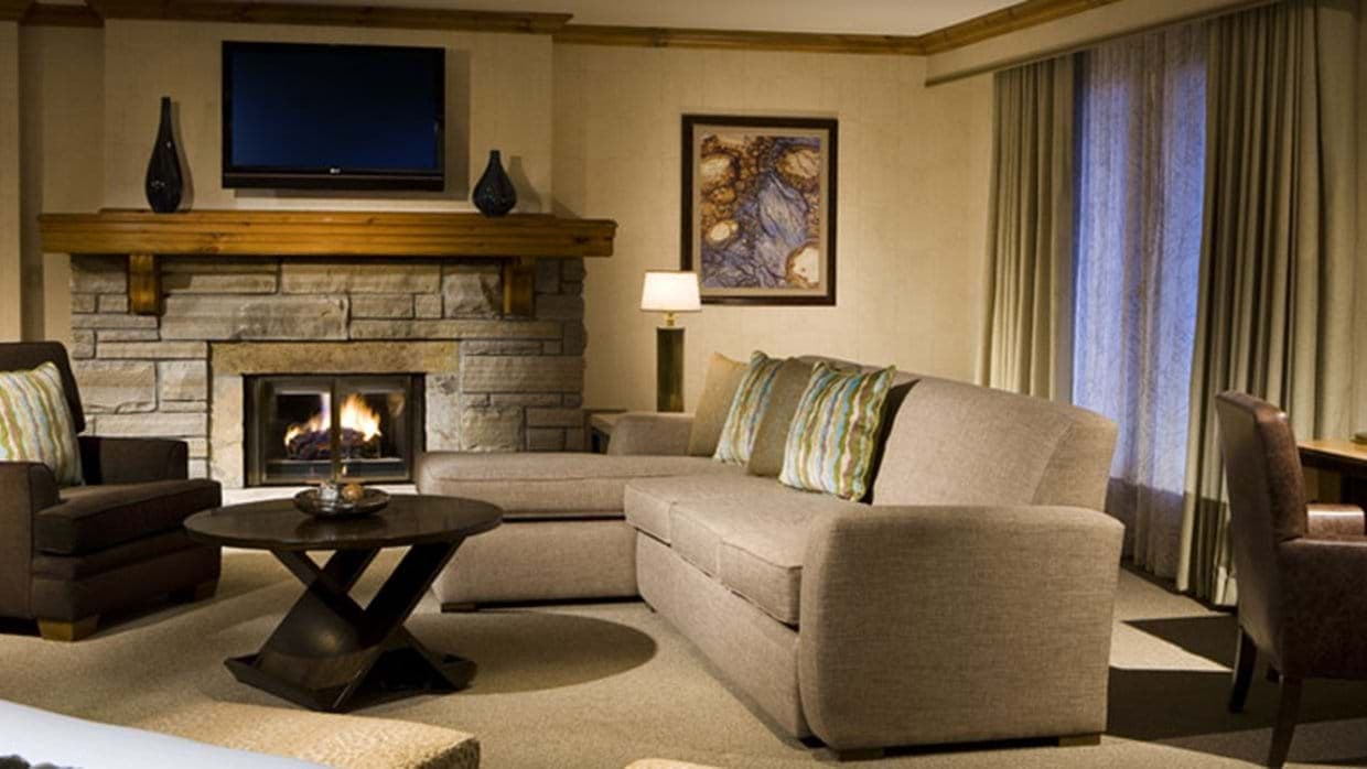 Living area with gas fireplace, chaise sectional, and wall-mounted TV