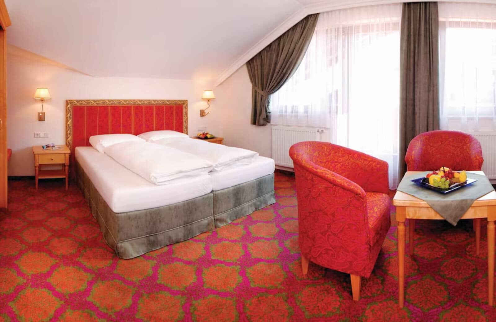 Guest bedroom with two twin mattresses and separate seating area