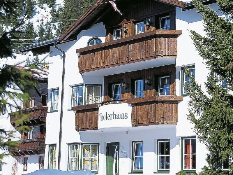 Chalet exterior with multiple private balconies and slope-side mountain location