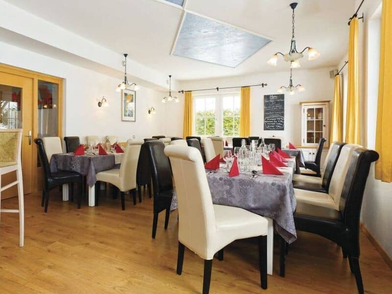 Dining room with multiple tables and seating for 16 guests