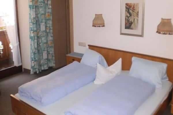 Guest bedroom with two twin beds and private balcony access