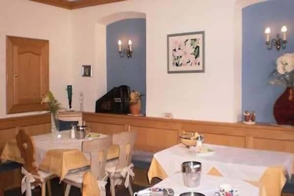Dining area with booth seating and traditional wood paneling