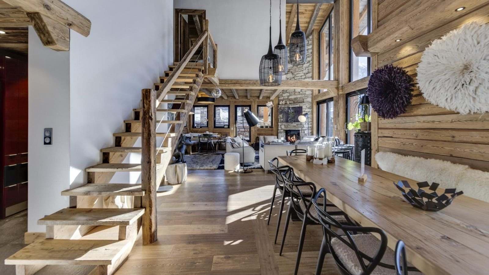 Open-plan dining area with bench seating and stairs to loft level