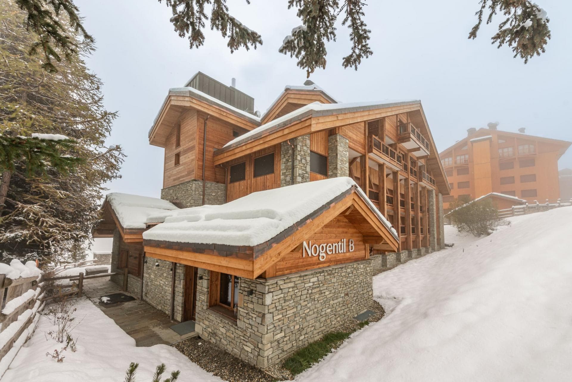 Nogentil B chalet exterior with stone facade and direct snow access