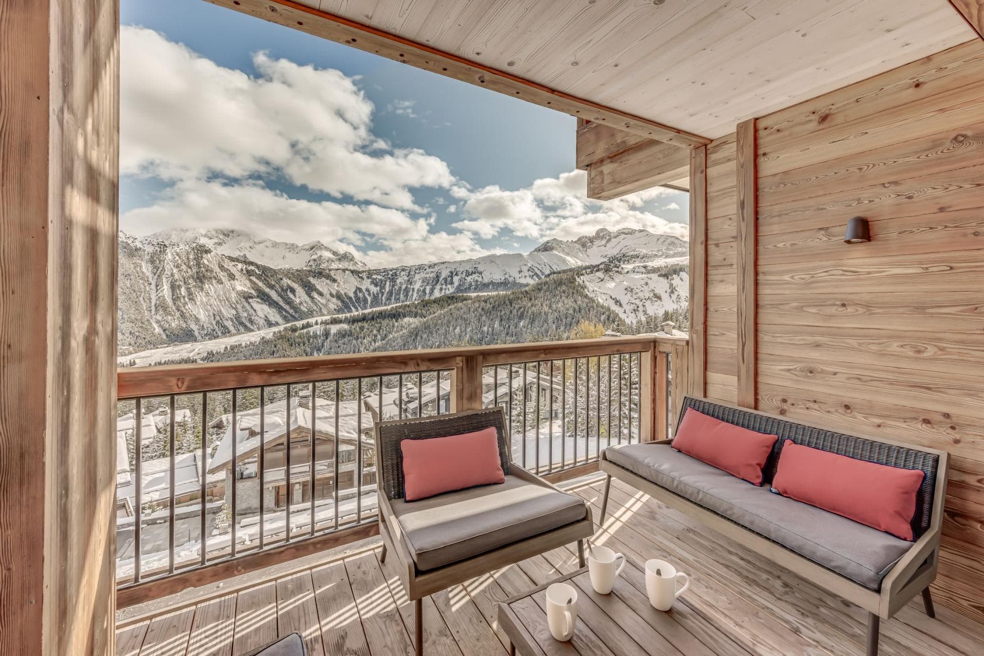 Covered balcony with lounge seating and panoramic mountain views