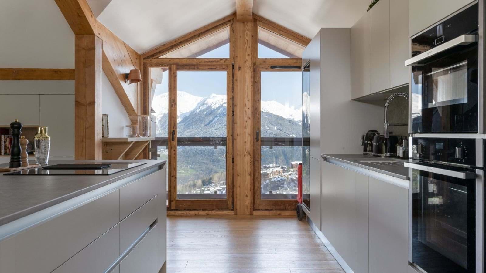 Kitchen with double wall ovens and panoramic mountain views