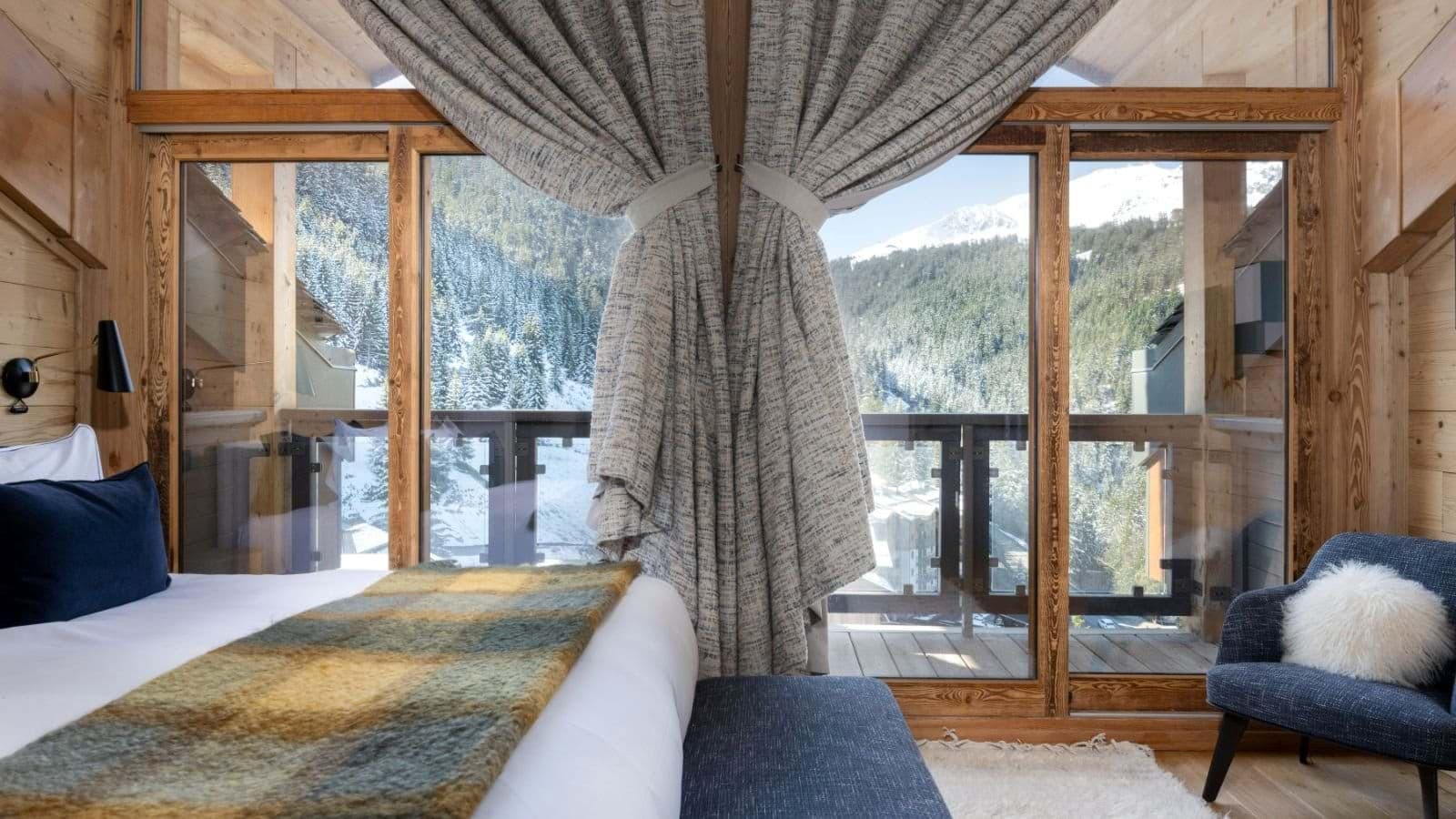 Bedroom with direct balcony access and mountain forest views