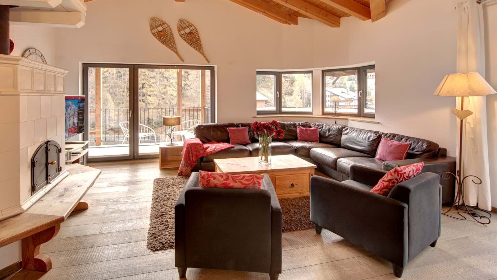 Living area with wood-burning fireplace and balcony access