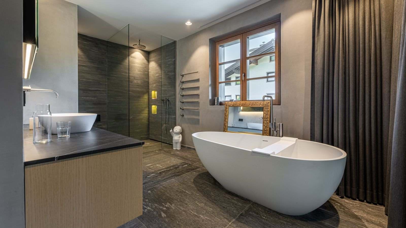 Bathroom with freestanding soaking tub and wall-mounted heated towel rack
