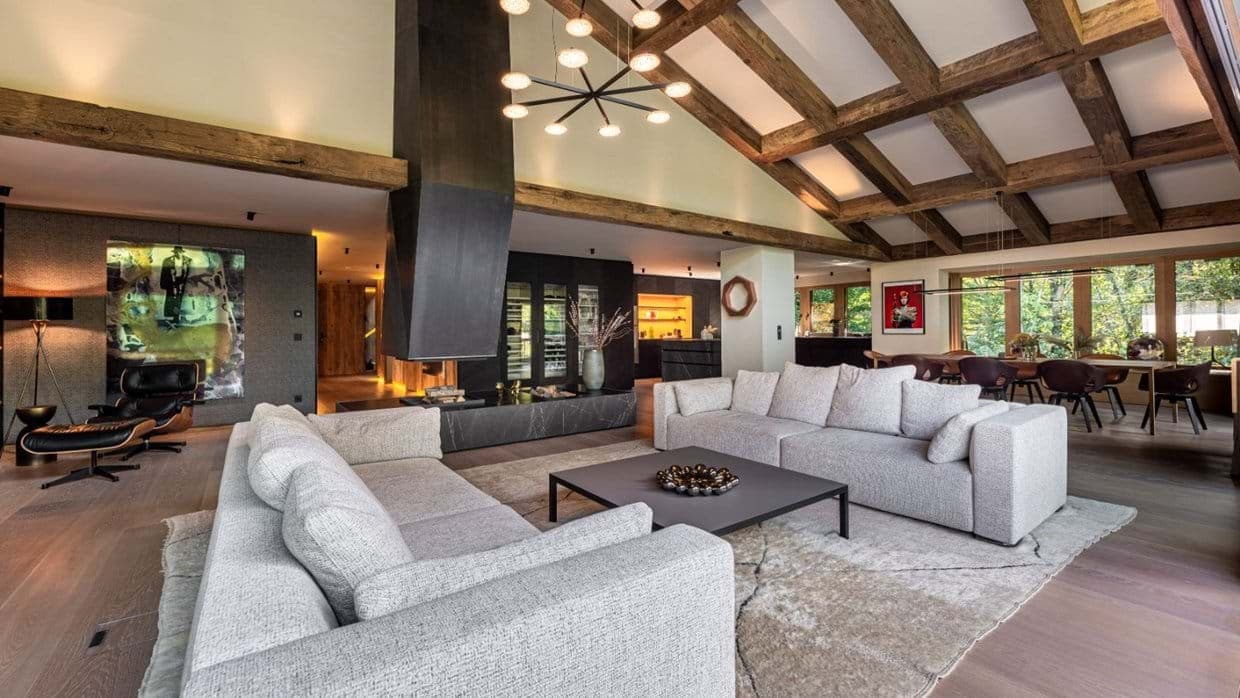 Living area with vaulted timber ceilings and central fireplace