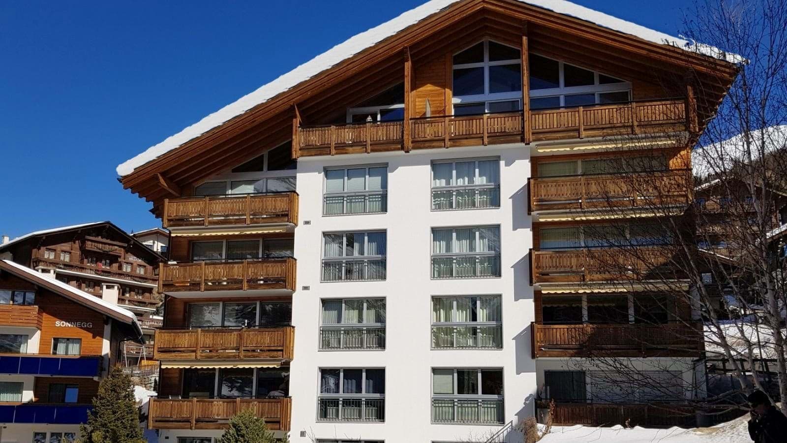 Chalet exterior with private balconies and south-facing mountain views