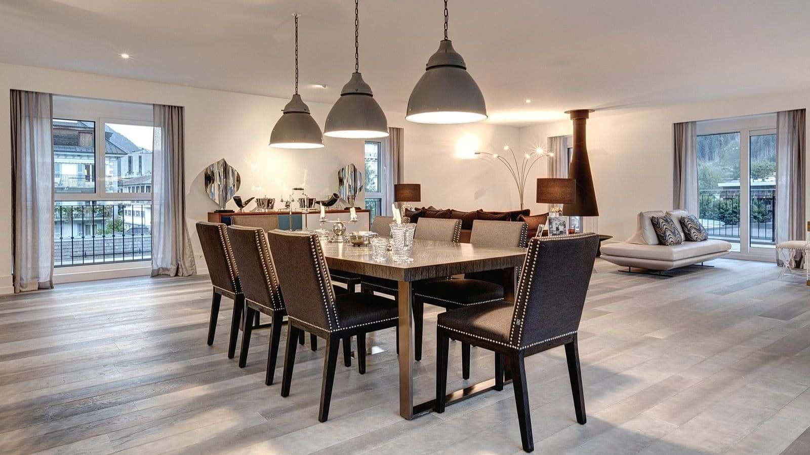 Dining table seats 8; open-plan layout with fireplace and balcony