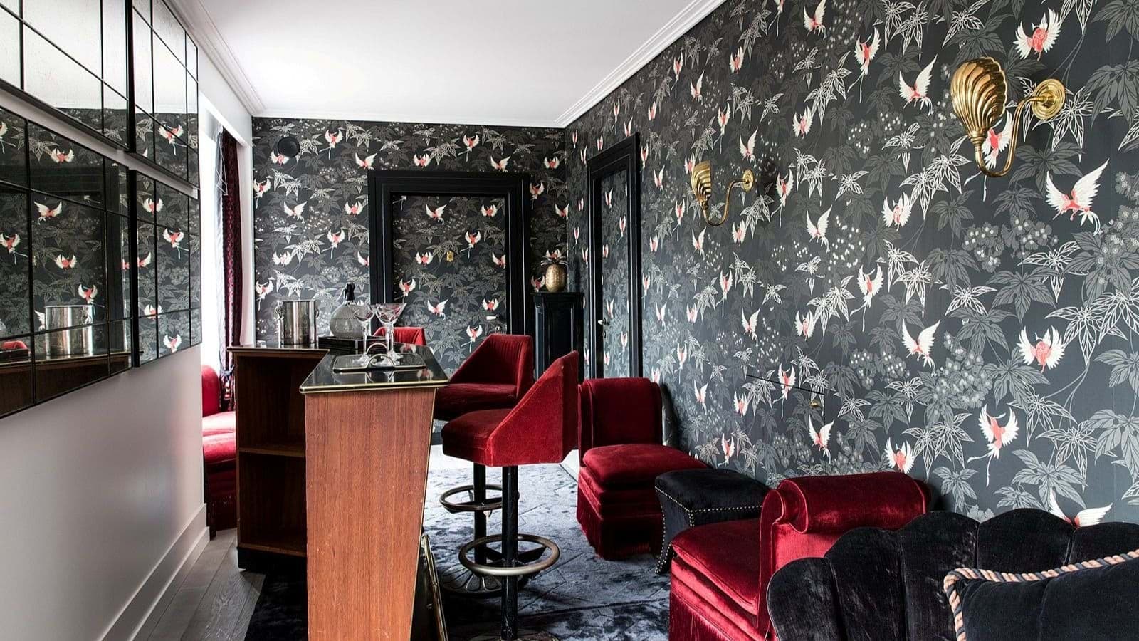 Private bar area with mirrored walls and red velvet seating for five