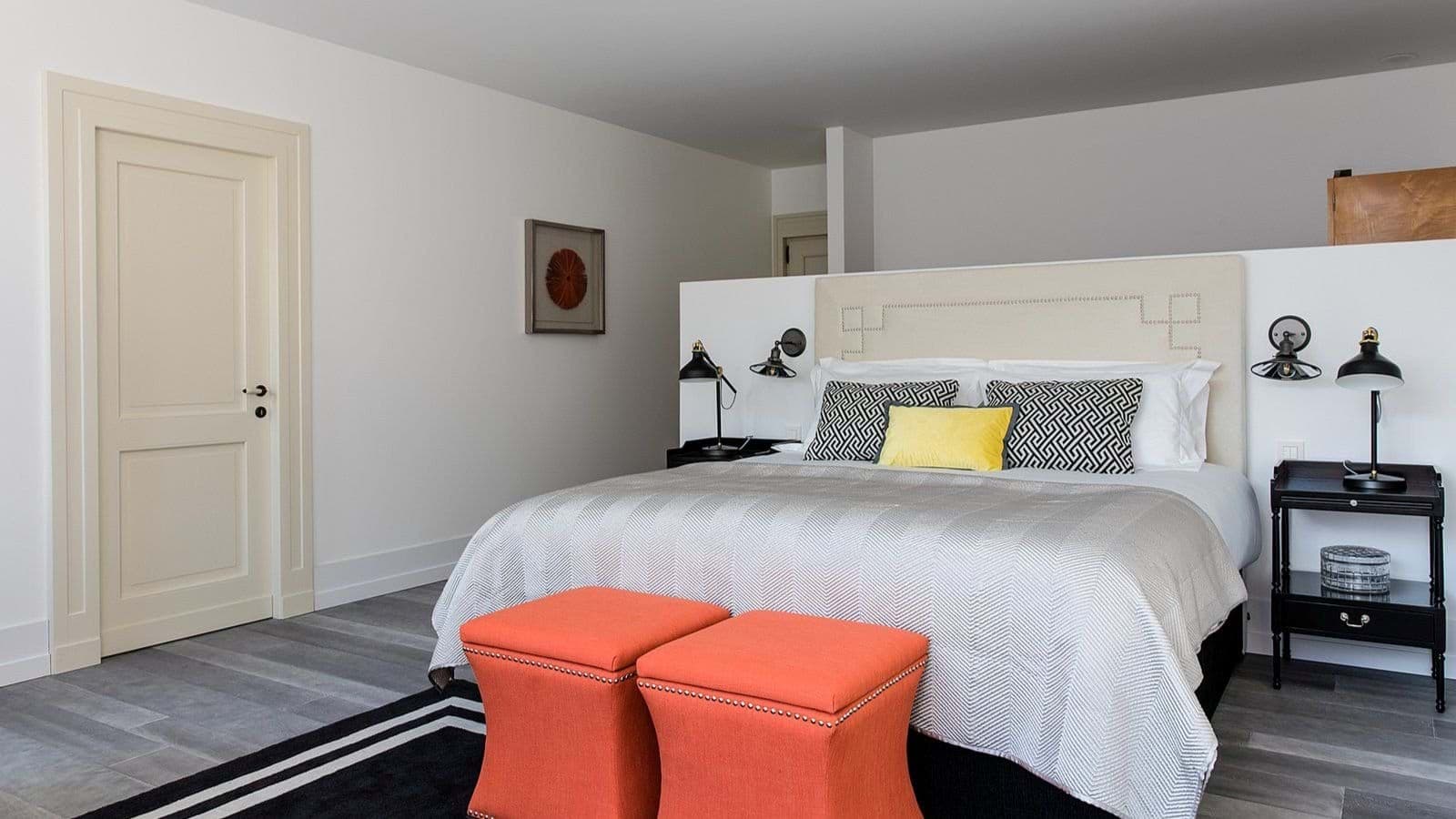 King bedroom with partition wall and dedicated bedside reading lamps