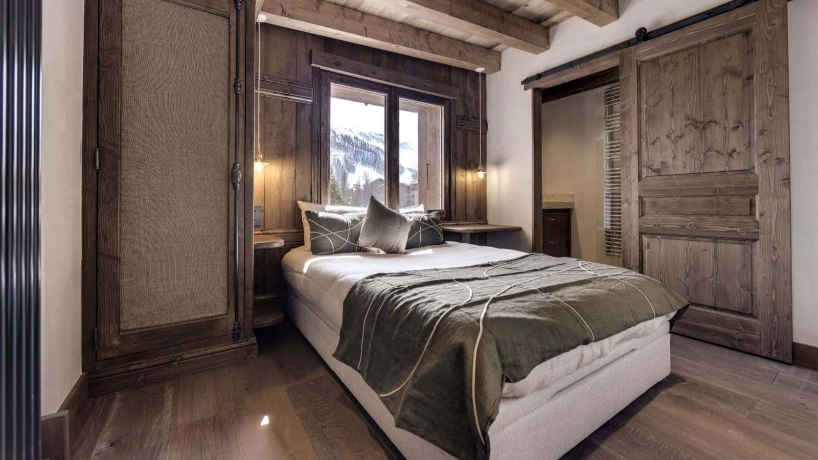 Bedroom with queen bed and snowy mountain views