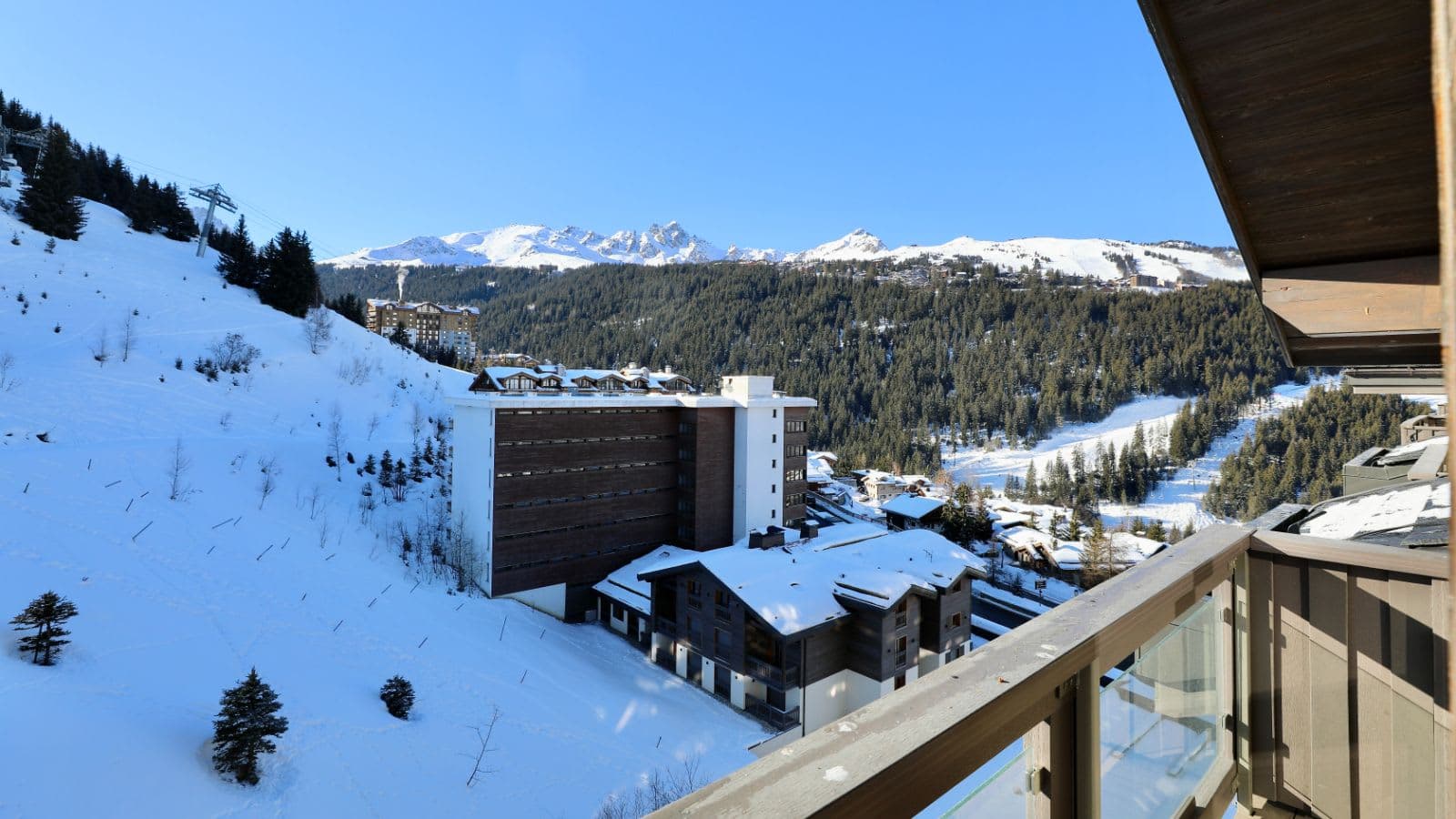 Private balcony with mountain views and direct ski-in/ski-out slope access