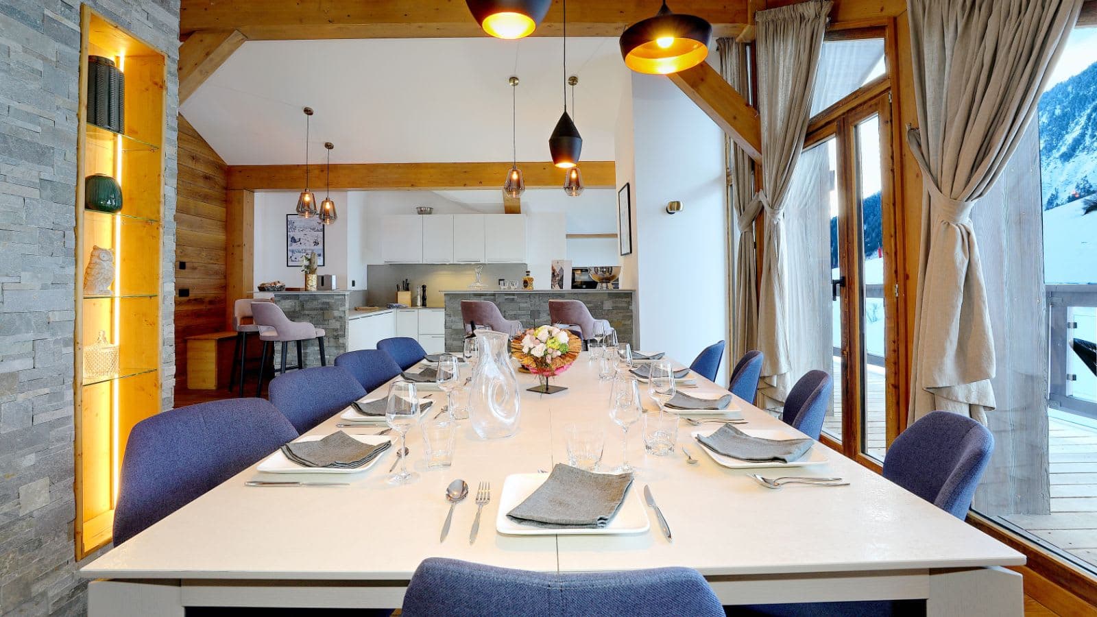 Dining area with seating for 10 adjacent to open-plan kitchen