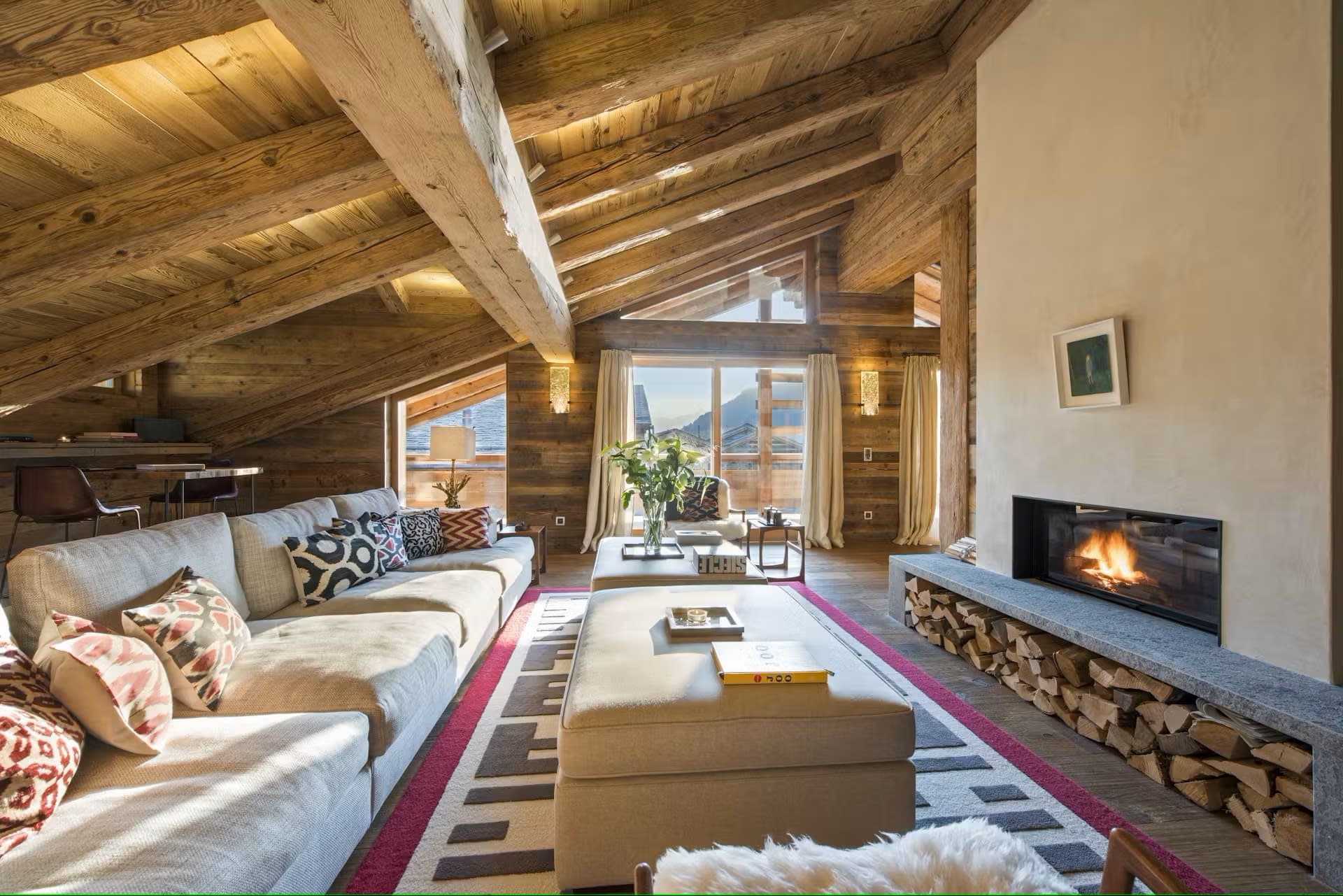 Living area with wood-burning fireplace and vaulted timber ceilings