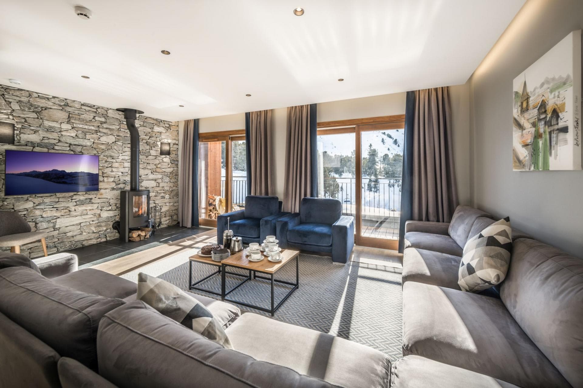 Living room with wood-burning stove and balcony access to lake views