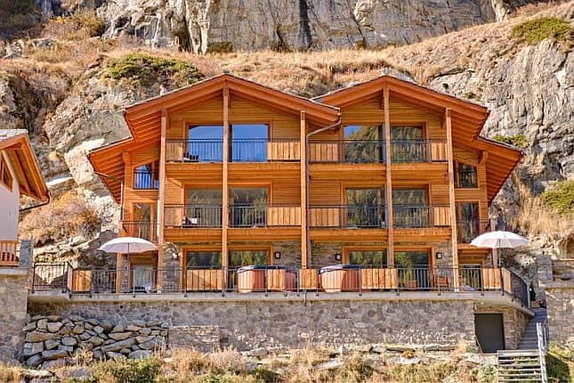Chalet exterior with private balconies and ground-floor hot tubs