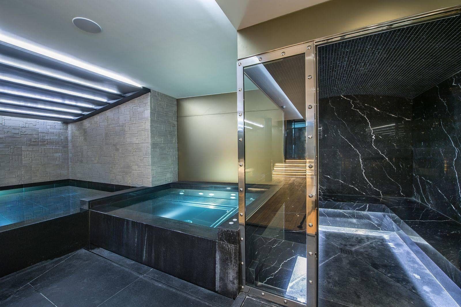 Private spa area featuring indoor plunge pools and marble-clad steam room