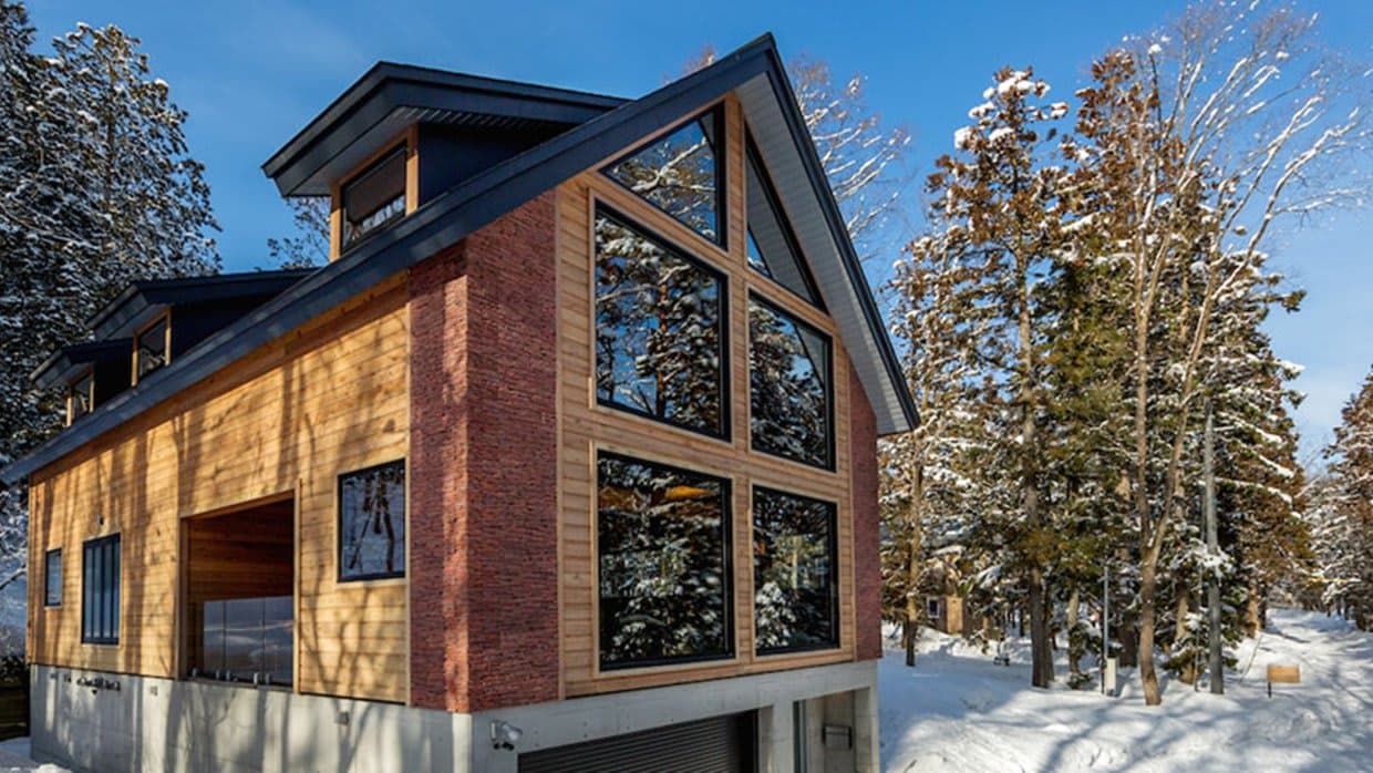 Chalet exterior with floor-to-ceiling windows and heated garage access