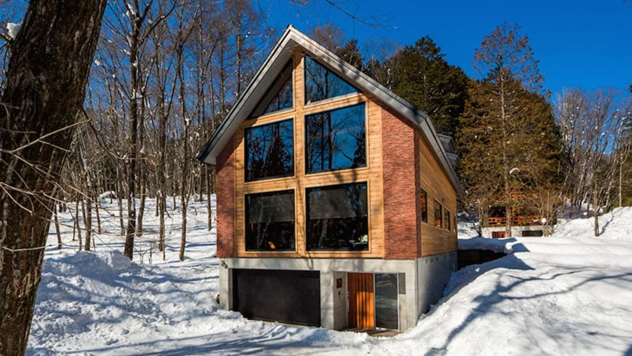 Chalet exterior with ground-floor heated garage and forest setting