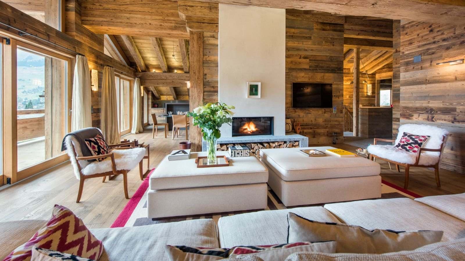 Living area with wood-burning fireplace and floor-to-ceiling windows