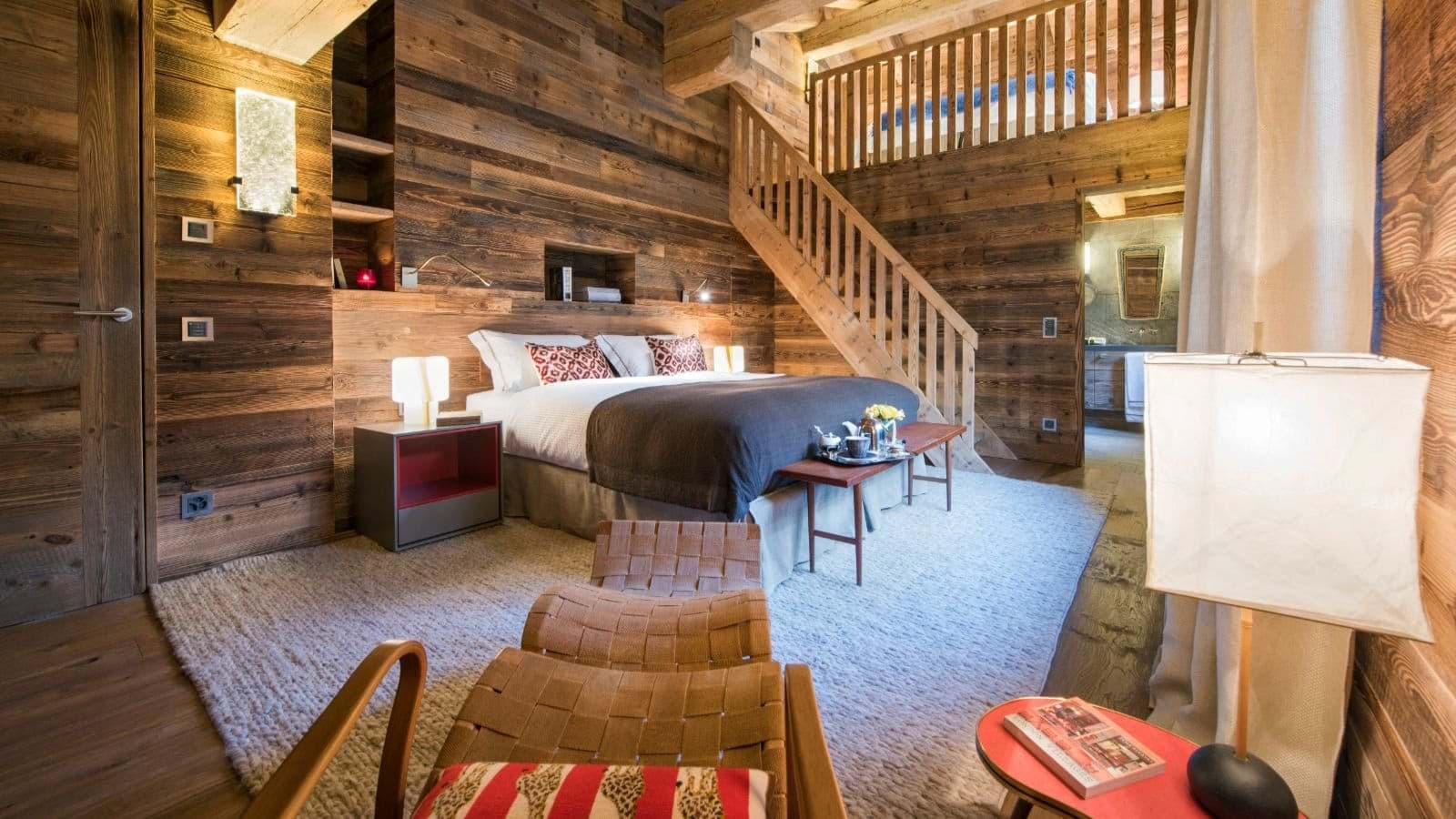 Primary bedroom with king bed and stairs to lofted sleeping area