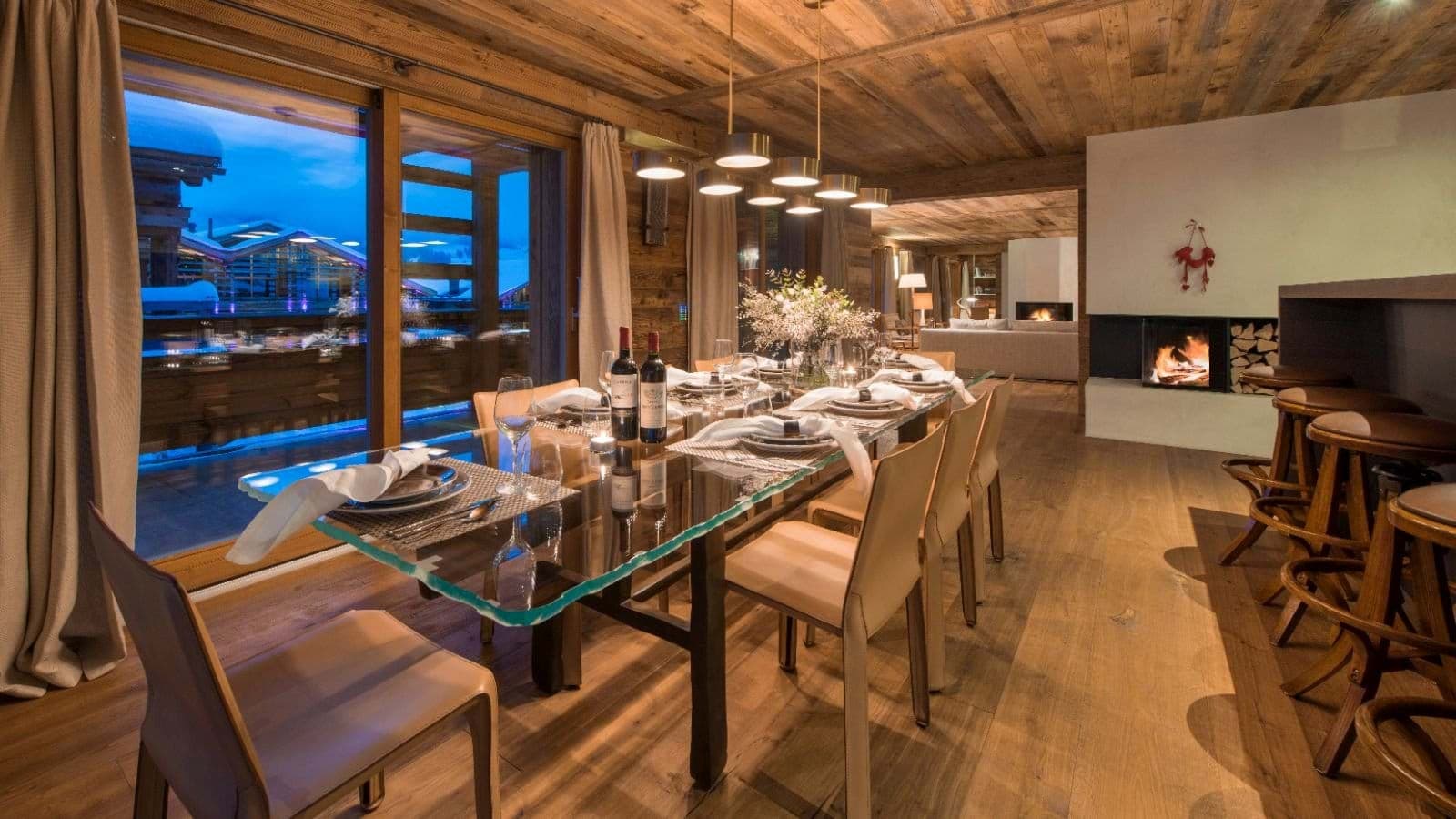 Dining area seats 10 with glass-top table and wood-burning fireplace