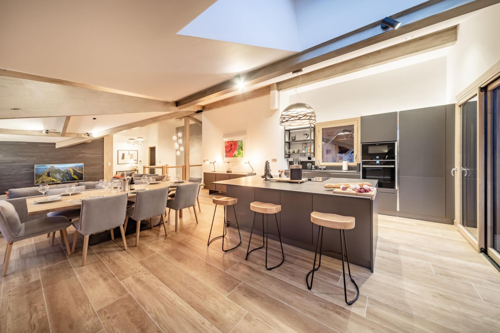 Open-plan kitchen and dining area with skylight and seating for 11