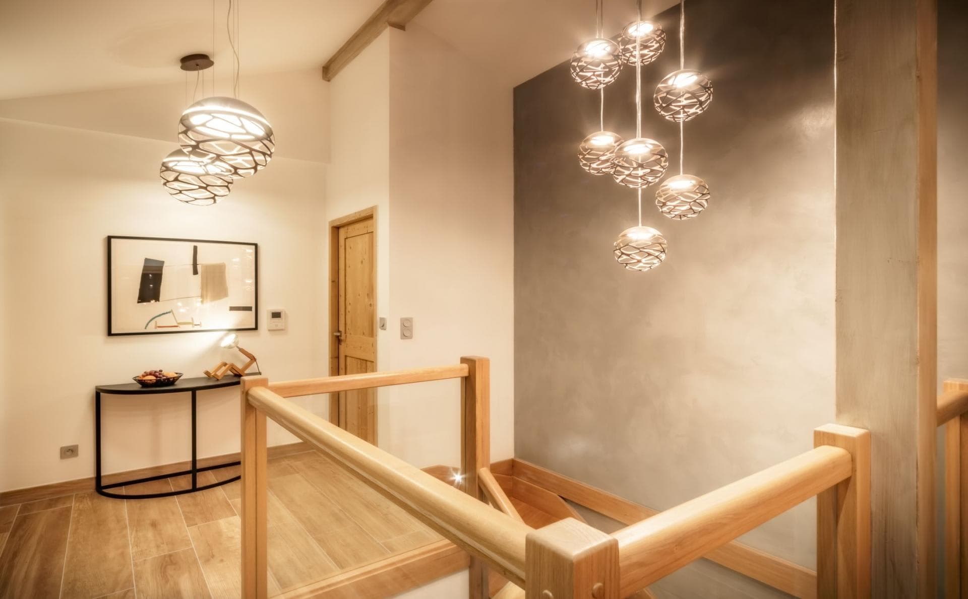 Upper floor landing with timber staircase and pendant lighting