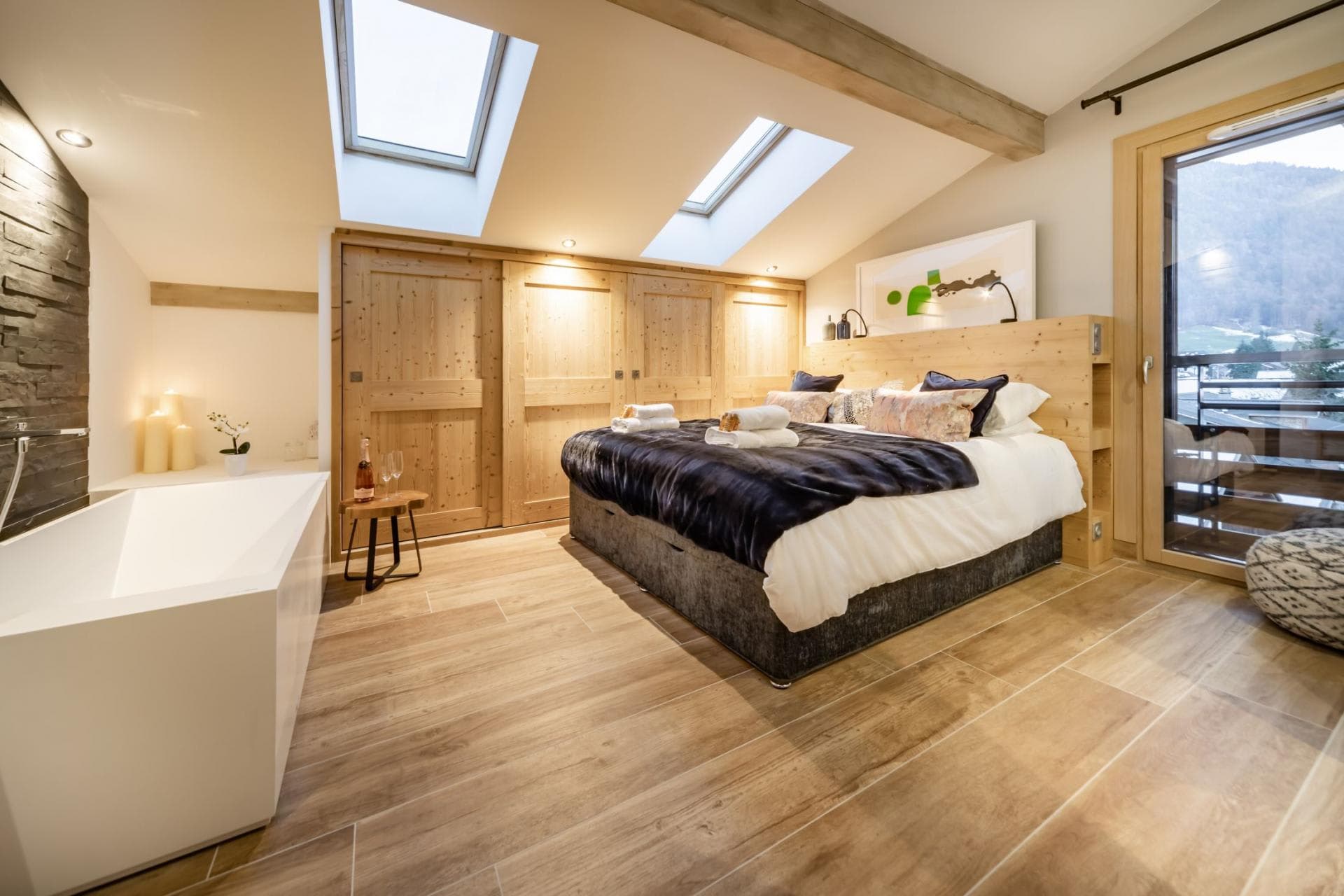 Primary suite with king bed, soaking tub, and balcony access