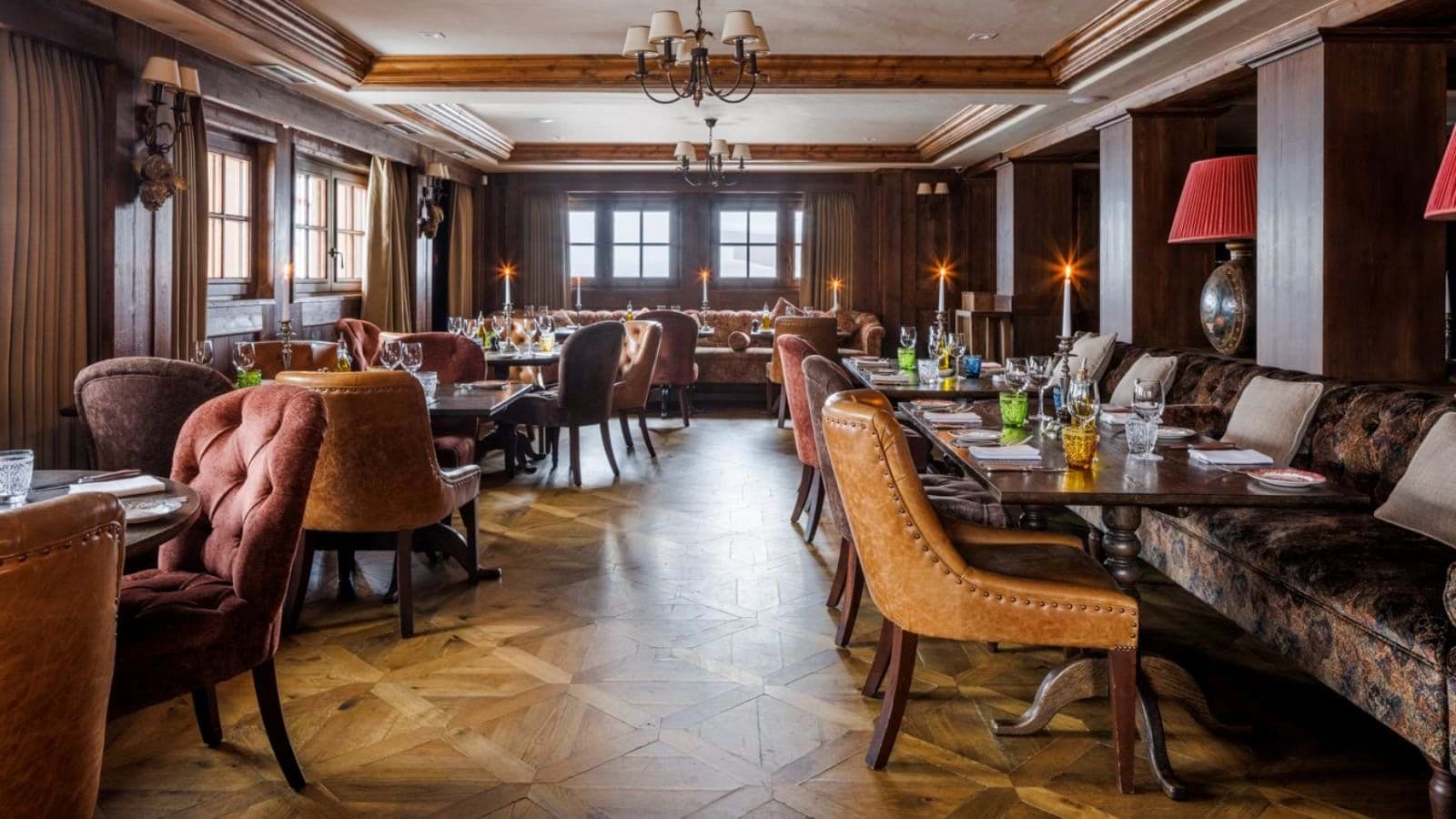 Dining room with wood paneling and booth seating for large groups