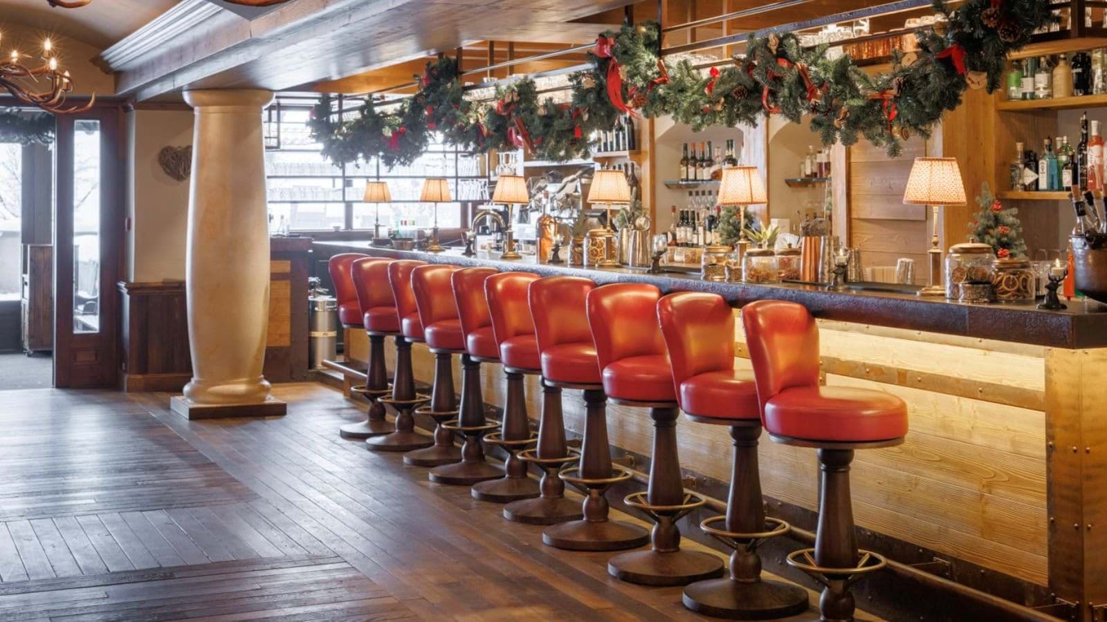 Full-service bar with seating for 10 and brass footrests