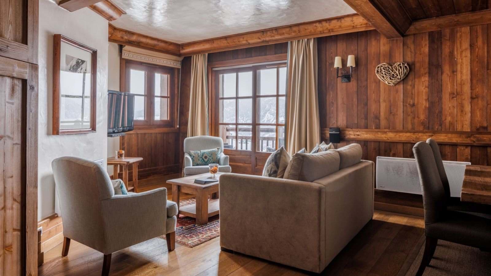 Living area with sofa seating and balcony access to mountain views