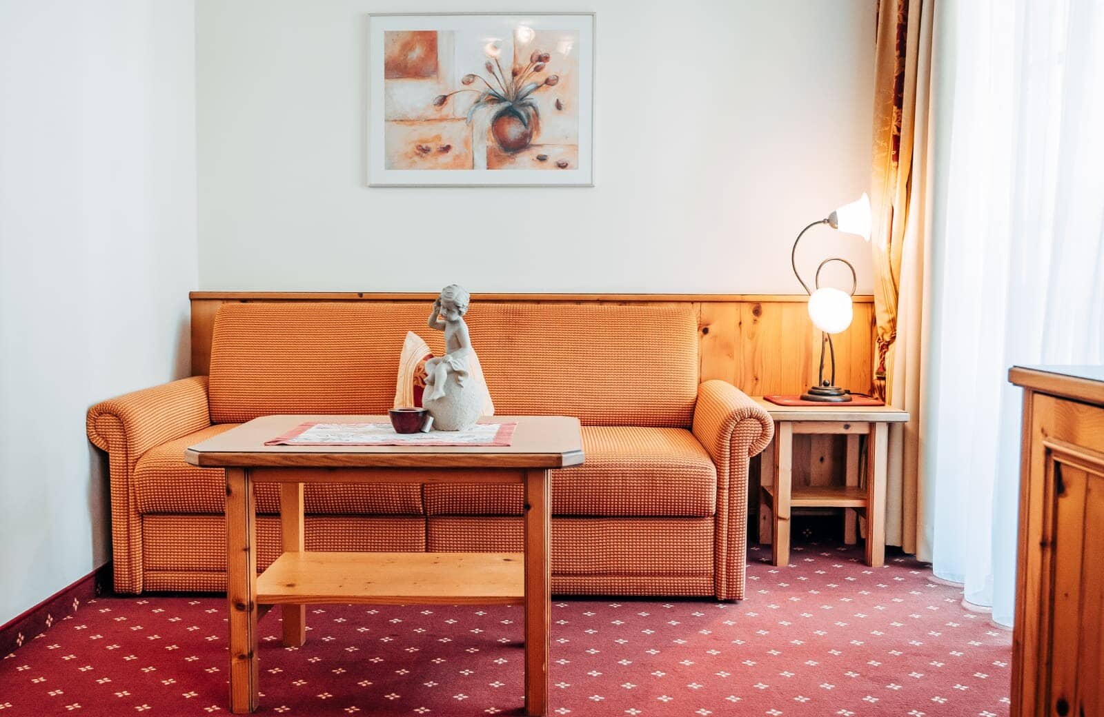 Living area with sofa bed and pine wood paneling