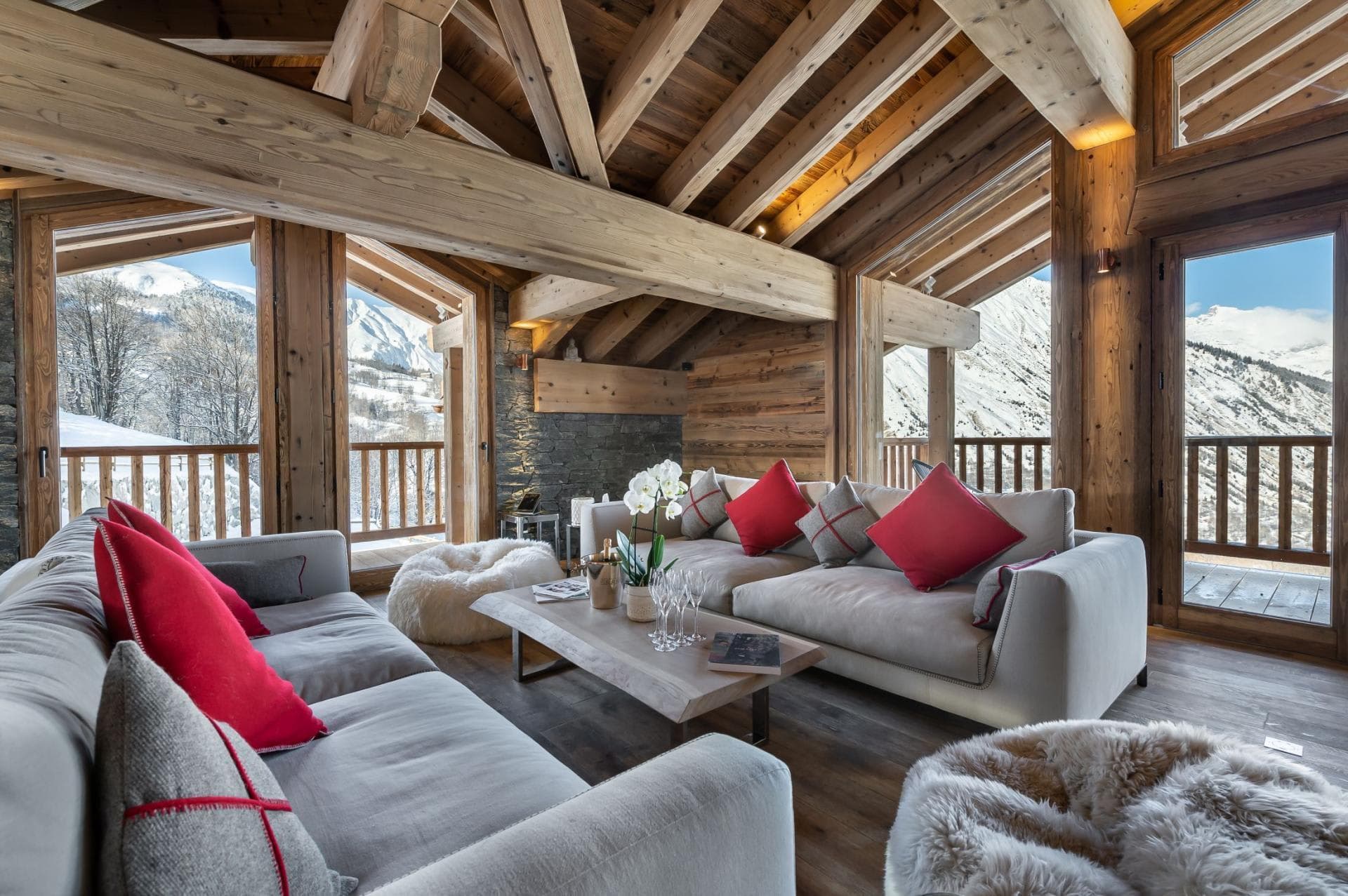 Living area with vaulted timber ceilings and wraparound mountain views