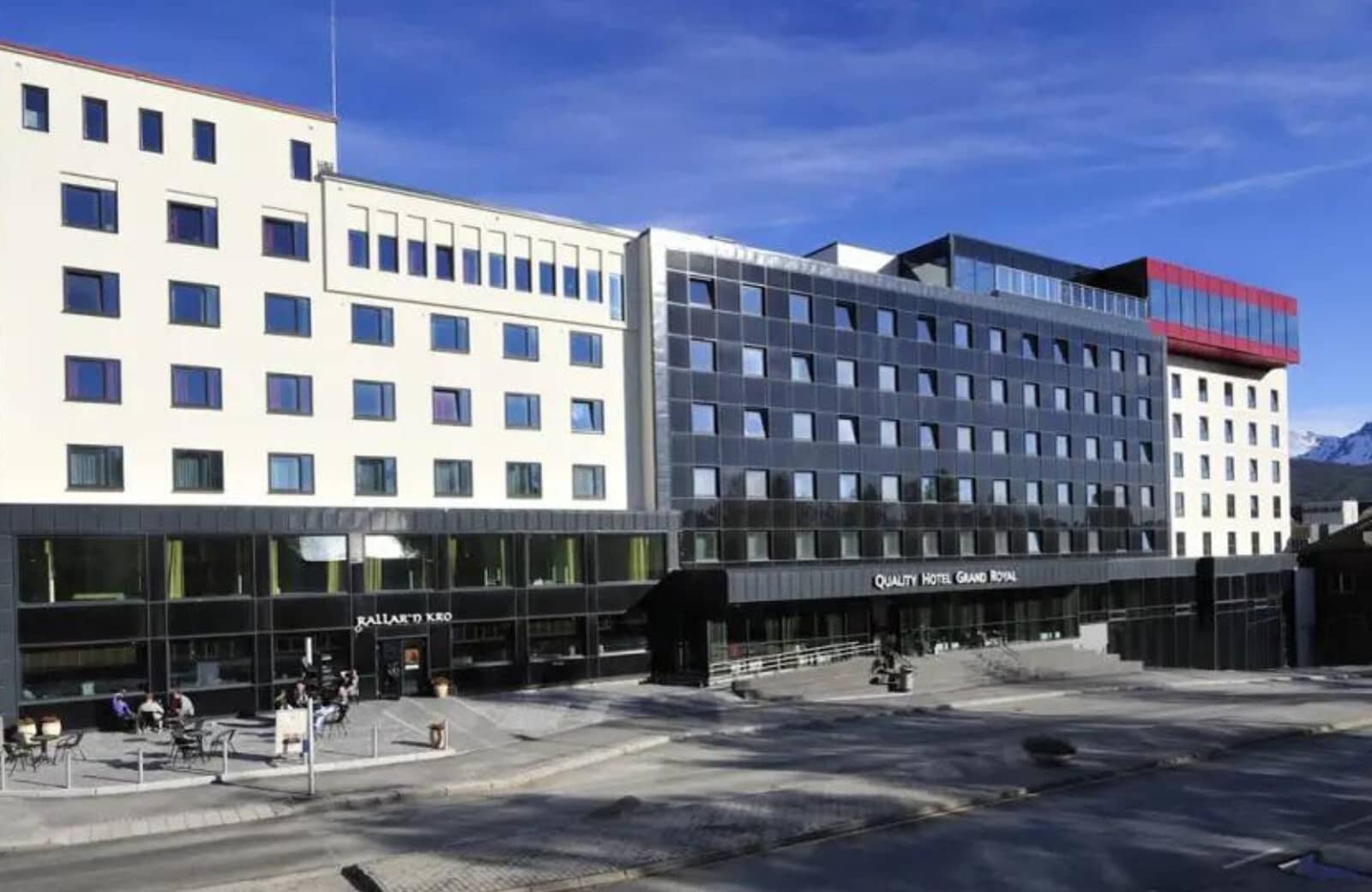Hotel exterior with ground-floor restaurant patio and street-level entrance